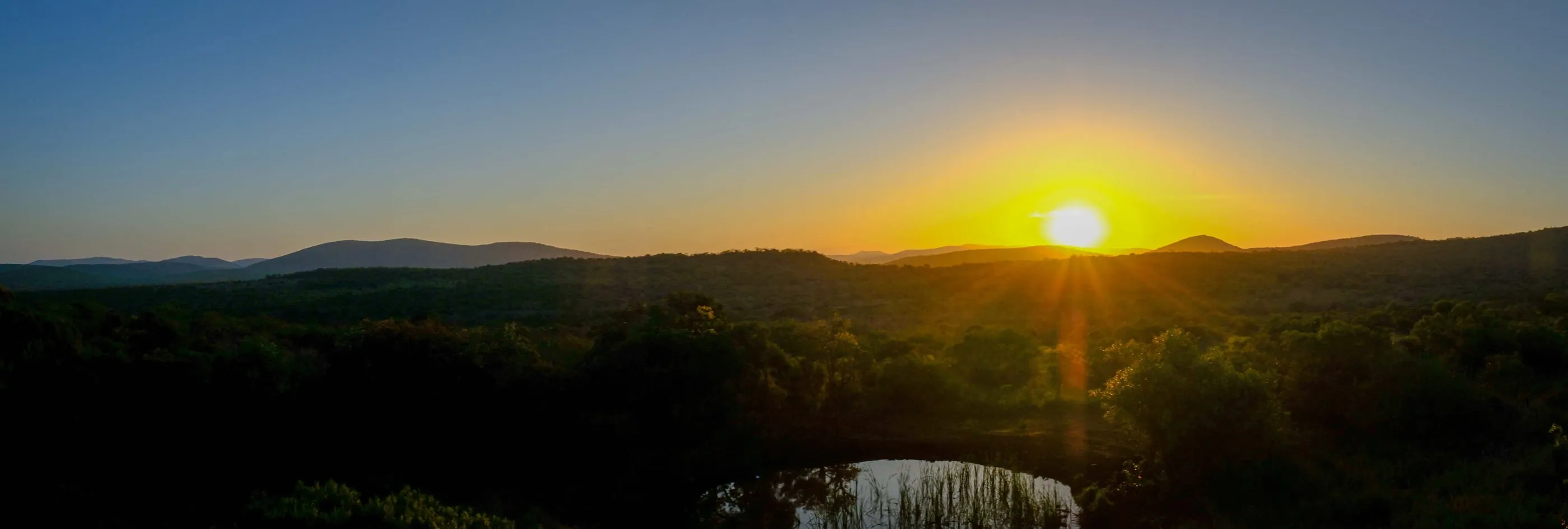 Sunset over a waterhole in the Zululand bush